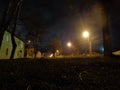 Autumn night town view on the street with trees and houses. Royalty Free Stock Photo