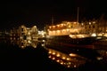 Autumn night on the Water of Leith a moored ship glows with reflections Royalty Free Stock Photo