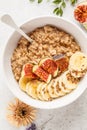 Autumn oatmeal with banana, fig and flax seed. White background, top view Royalty Free Stock Photo