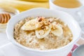 Autumn oatmeal in white bowl banana honey