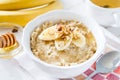 Autumn oatmeal in white bowl banana honey