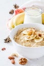 Autumn oatmeal in white bowl banana honey