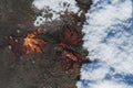 autumn orange maple leaf on asphalt frozen in ice in the first snow in winter Royalty Free Stock Photo