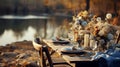 Autumn outdoor dinner table on a riverbank, with a simple wooden table and folding chairs