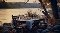 Autumn outdoor dinner table on a riverbank, with a simple wooden table and folding chairs