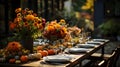 Autumn outdoor dinner table setting with flowers and pumpkins, vertical, fall harvest Royalty Free Stock Photo