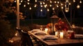 Autumn outdoor dinner table setting with lanterns and bulb lights,