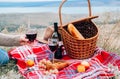Autumn outdoor picnic set. A bottle of red wine, two wine glasses, checked plaid, grape, apple and cookies. Royalty Free Stock Photo
