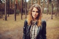 Autumn outdoor portrait of young beautiful woman with natural makeup in leather jacket and plaid shirt Royalty Free Stock Photo