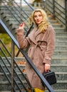 Autumn outfit. Woman wear stylish outfit and carry purse. Outerwear of modern warm and stylish eco fur. Girl in warm