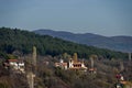 Autumn panorama of part of a residential area with a church with modern architecture and a bell tower, Katina village