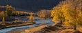 Autumn Panoramic Landscape Of A Mountain Valley With Emerald River, Yellow Larch And Poplar Grove, Lit By The Sun. Autumn Forest W