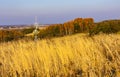 Autumn view of hill fields and meadows with field cross shrine surrounding Zagorzyce village in south-eastern Poland