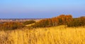 Autumn panoramic view of hill fields and meadows with forest surrounding Zagorzyce village in Podkarpacie region of Poland