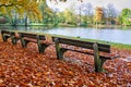 Autumn park bench landscape.Bench in autumn park near pond in LÃÂ¼beck. Royalty Free Stock Photo