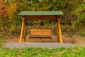 Autumn park bench. Tree alley in fall background Royalty Free Stock Photo