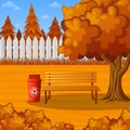 Autumn park bench under the tree with trash bin Royalty Free Stock Photo