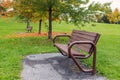 Autumn in the park. Benches and trees with fallen colored leaves after rain Royalty Free Stock Photo