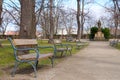 Autumn in park with benches. Trees and statue under blue sky. Prague, Vysehrad