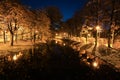 City park at twilight. Trees, river, street lights and alley. Autumn night park. Royalty Free Stock Photo