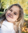 Autumn park: portrait beautiful little girl Royalty Free Stock Photo