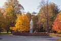 The Janko Kral City Park in Bratislava, autumn leaves on the huge trees and statue of the poet in the centre