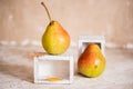 Autumn pear in a white old wooden small box. Life style. Yellow autumn leaves on a concrete light background. Selective focus, spa Royalty Free Stock Photo