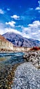 Autumn perfection river flows rocks & mountain cloudy sky