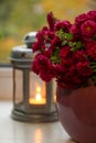 Autumn pink chrysanthemum flowers in a violet vase with lantern