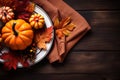 Autumn place setting with fall leaves, napkin and pumpkins. Thanksgiving autumn place setting with cutlery and arrangement of fall