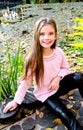 Autumn portrait of adorable smiling little girl child in the pa