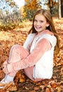 Autumn portrait of adorable smiling little girl child preteen in the park