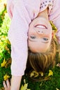 Autumn portrait of adorable smiling little girl child standing upside down on grass and having fun Royalty Free Stock Photo
