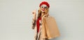 Autumn portrait of attractive smiling woman with shopping bag wearing a coat, red french beret Royalty Free Stock Photo