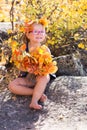 Autumn portrait baby holding yellow Leaves