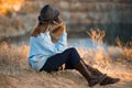 Autumn portrait of beautiful girl in black hat and blue sweater