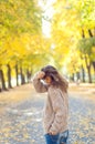 Autumn portrait of a beautiful woman. Happy young woman walking in autumn park. Young woman resting in autumn forest.