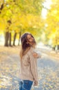 Autumn portrait of a beautiful woman. Happy young woman walking in autumn park. Young woman resting in autumn forest.