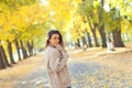 Autumn portrait of a beautiful woman. Happy young woman walking in autumn park. Young woman resting in autumn forest.