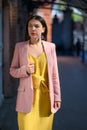 Woman in yellow dress and pink blazer Royalty Free Stock Photo