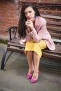 Woman in yellow dress and pink blazer Royalty Free Stock Photo