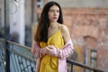 Woman in yellow dress and pink blazer Royalty Free Stock Photo