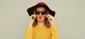 Autumn portrait beautiful young woman showing mustache her hair blowing red lips wearing an yellow knitted sweater, hat on gray Royalty Free Stock Photo