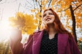 Autumn portrait of candid beautiful red-haired girl with fall leaves in hair. Royalty Free Stock Photo