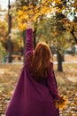 Autumn portrait of candid beautiful red-haired girl with fall leaves in hair. Royalty Free Stock Photo