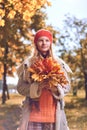 Autumn portrait of cute girl in red hat and coat