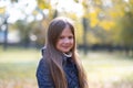 Autumn portrait of cute little blond girl in city park. Beautiful smiling child having fun outdoors on a warm fall day Royalty Free Stock Photo