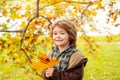 Autumn portrait of cute little boy. Child with leaf in autumn park. Royalty Free Stock Photo