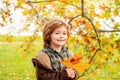 Autumn portrait of cute little boy. Child with leaf in autumn park. Royalty Free Stock Photo