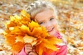 Autumn portrait of cute smiling little girl with maple leaves Royalty Free Stock Photo